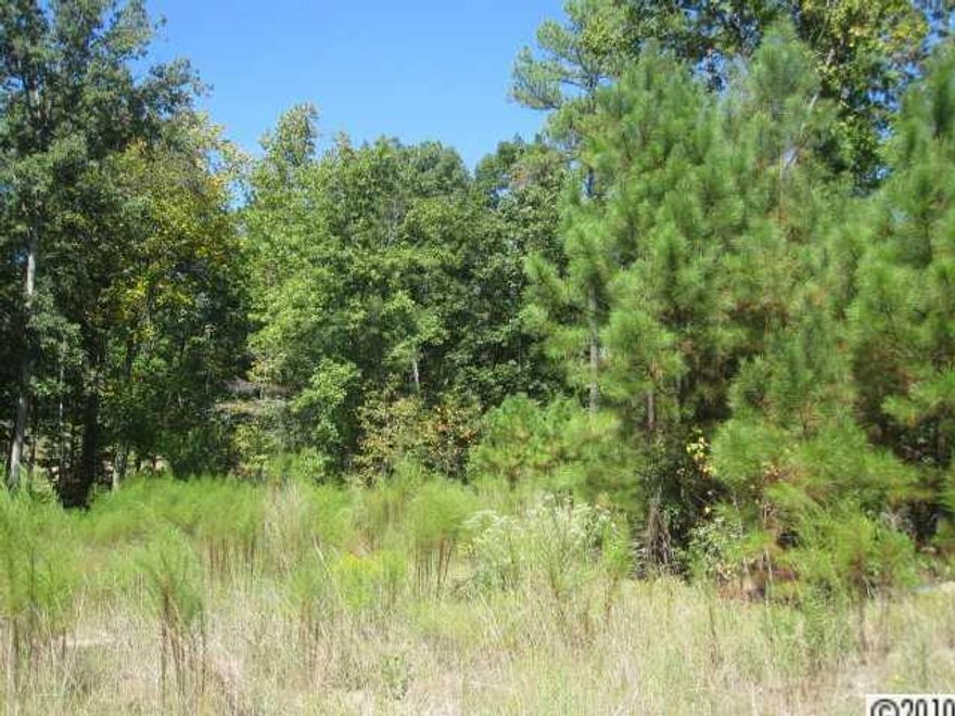 Wooded lot in waterfront community. Neighborhood pool & walking trails, boat & RV storage for residents. Bank owned