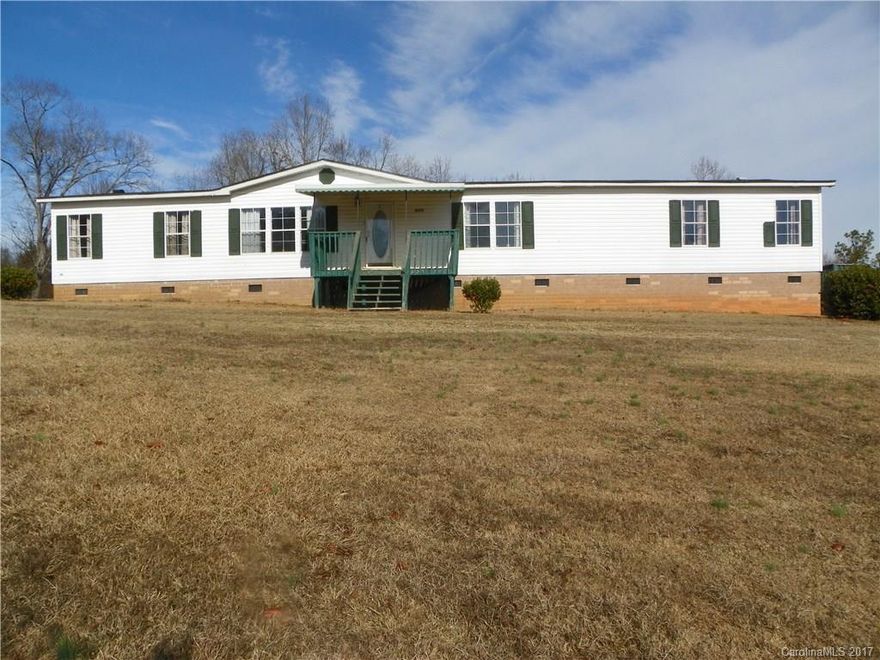 With over 1900 sq ft, 3 bedrooms and 2 full baths sitting on 1.8 acres. There is a beautiful fire place in the family room, and a garden  tub in the master bath not to mention the 2 car carport and the land.The kitchen is equipped with a refrigerator and a new dishwasher. The dining room, living room and all bedrooms are fully carpeted.  There is also a big pear tree in the backyard with patio with access to the convenience.  This won't last long. Home being sold as is.