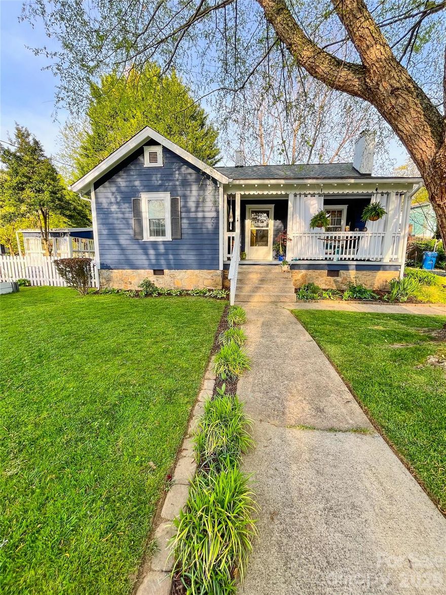 Overflowing with charm and priced to move, this well-maintained 3BR/2BA home blends style, comfort, and thoughtful updates. Located just over a mile from Downtown Waynesville and near the Country Club, this is an opportunity you don’t want to miss.

From the moment you arrive, the inviting covered front porch sets the tone with year-round mountain views, perfect for morning coffee or relaxing sunsets. Inside, you’ll find fresh paint, artistic touches, and updated finishes that make this home truly stand out.

The main home features two bedrooms and a full bath, while a private rear suite with its own bedroom and bath offers ideal guest accommodations or excellent Airbnb potential. A cozy living room with a wood-burning fireplace and a bright kitchen create a warm, welcoming feel, complemented by a dedicated laundry area with sink for added convenience.

Outside, enjoy a fenced backyard and patio perfect for pets or entertaining, along with a carport, storage, and private driveway.

This lovingly cared-for home is full of personality and potential, with a seller welcome to consider all reasonable offers, this is your chance!