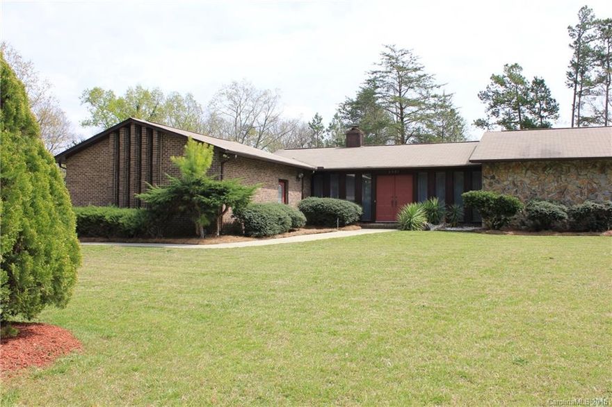 Beautiful mid-century modern ranch home nestled on a half-acre corner lot, close to shopping, and minutes from I-77. Large great room with fireplace and a wet bar, opens to the formal dining room. Both have access to the back patio. The kitchen has it's own private patio, breakfast area, updated appliances and wall pantry. Master bedroom has a walk-in closet, hardwood floors and separate shower & vanity areas. Security system and updated garage door opener included.