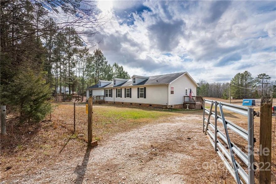 Welcome to the homestead on historic Henry Harris Road (in the Indian Land Community).  The beautiful 2000sq ft home boasts raised garden beds ready for planting, culinary herbs that surround the home.  The home, itself sits on 1.06 acres of green and the remaining acreage behind the home can be purchased.  BEAUTIFUL sunsets every evening on your back porch and newly added patio area.  The kids will enjoy the NEWLY installed playset in the backyard.  Inside you’ll find LIFEPROOF vinyl plank flooring with cork padding running the entire length of the home and carpet in bedrooms.  The new smooth cooktop, new refrigerator, and dishwasher are all included in the sale.  If you have a green thumb and want a nice, productive garden or maybe you just want a nice, quiet slice of peace only minutes from town, this is the slice for you! - *Note: BARN NOT included in the parcel for sale*
