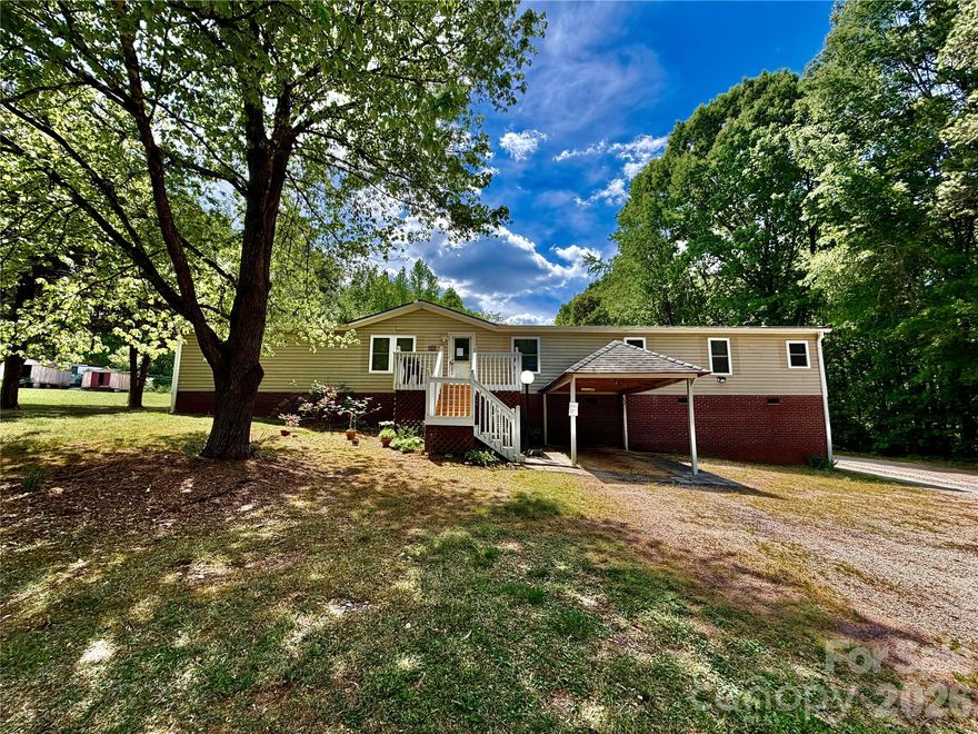 Spacious and versatile double-wide mobile home thoughtfully designed with a split layout offering two distinct living areas, each with its own private entrance, yet connected inside by two separate access doors for convenience.  The back side of the home  features a full kitchen, dining area, and comfortable living room, along with a primary bedroom with a private bath and an additional secondary bedroom.  The front side of the home, with its own separate entrance, offers a living room, kitchen with eat-in dining, a bedroom, an office, and a full bathroom - providing excellent flexibility for a variety of living arrangements.  Ideal for multi-generational living, guests, or added privacy for household members.  A rare find with adaptable space to fit your needs!  Updates include: Roof replaced approximately 6 years ago, AC unit replaced approximately 10 years ago, well recently repaired with 7 year warranty.  Foundation inspected by Morton Engineering and confirmed FHA compliant.  Permanent foundation systems installed. Windows replaced approximately between 6-8 years ago.