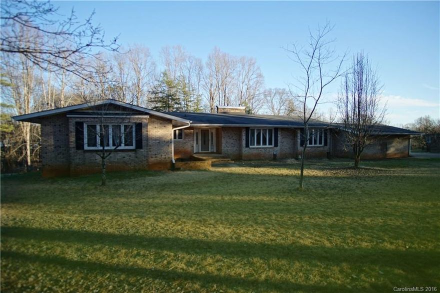 Minutes to downtown Charlotte, yet away from it all on 2.33 acres! This brick ranch home is wonderfully located; off I-85 South/Exit 26. Features include a step-down master bedroom with direct access to sun porch that runs along rear of the house, generously sized bedrooms, stone fireplace surrounds, a 3,004 sf basement with bar, small performance stage, half bathroom, workshop, storage, bonus area, trees galore, HORSES OKAY and private well. This home is just waiting for your personal touch!