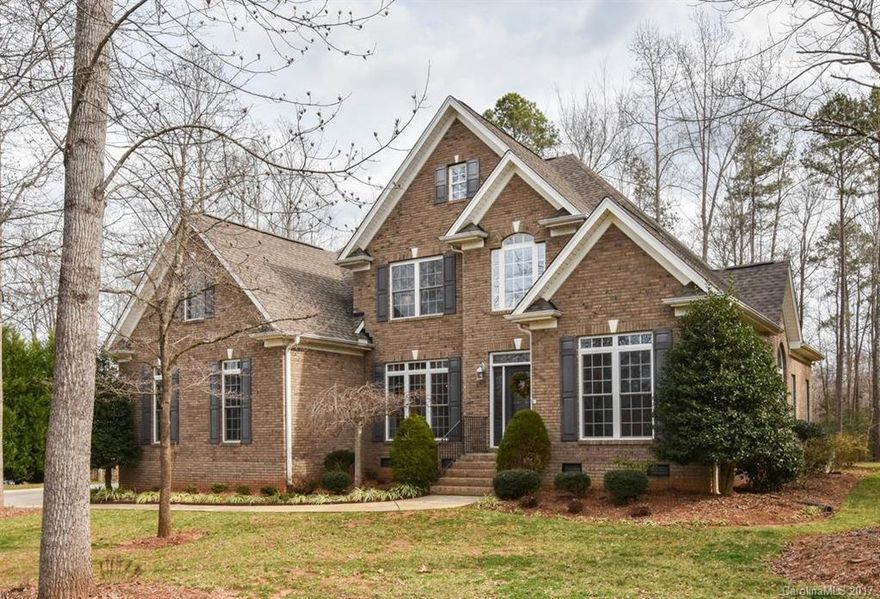 All brick custom built home-4BR's 2.5 BA's. Surrounded by woods for privacy. Open floor plan,2 story foyer and great room. Large kitchen and breakfast room with new SS appliances. There is a hook up for gas stove-currently electric. Lots of hardwood floors. Master Bedroom on main with DLB tray ceiling and large master bath with double vanities and separate shower and whirlpool tub. Screened in porch. Water softener installed. Great home for entertaining! Agent owned.Award winning Clover schools.