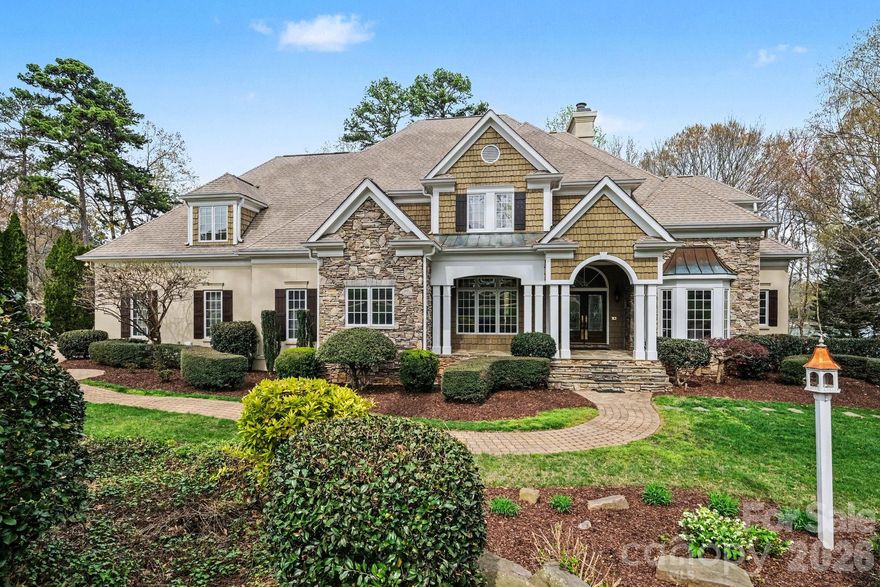 Prestigious waterfront location in the Village just steps to all the amenities of Trump National. Jocelyn Dienst built home, waterfront with personal dock, set privately back from the road, pool, hot tub, main and lake level full kitchens, with an elevator to all three levels. Newly refinished white oak long board floors, new carpet in all bedrooms, new flooring in the basement. Luxurious primary suite on the main level with patio access, lake view, luxury bath and expansive closet. Each of the 4 upstairs bedrooms is a suite with private bath. The lake level basement features over 2100 square feet of entertaining space, full bath with outdoor access to the pool and floating dock, full kitchen with gas range, included billiard table, and a huge screened porch.

This is the owner's story-"We bought this house from Jocelyn Dienst, who lived in the home and was one of the original Point Builders. The 4 upstairs suites were perfect for us and a guest quarters. The location was exactly what we wanted. Being so close to the club, getting to all the activities was a breeze. Having a dock in a short cove open to the bigger water, gave us easy access to the lake away from the wake splashes. Hole #9 is across our cove. You can watch your friends try and drive it over the water.
We painted the whole house and redecorated it about 20 years ago when we moved in. Then we enclosed the screen porch into a four seasons room about 10 years ago.  5 years ago, we put on a new roof, painted the exterior, and re-surfaced the pool and deck.  To present the house to the market, we neutralized all the most dramatic paint colors to enable you to more easily see your décor. The hardwood floors were refinished, the bedroom carpets are new, and the basement floor is new. The HVAC systems for the basement and main floor are new. The HVAC systems for our suite and the upstairs were serviced, as well as every other mechanical system in the house. Our goal is to present our home to you in the best possible working condition, at a value that will enable you to select décor changes that make this home work for you. 
Jocelyn used this home to show off features like our elevator. We thought it would be perfect for my wife's mom to use. Mom went to assisted living. We ended up using it when we banged up our knees. The kids and us enjoyed the basement for everything from their play space to our parties. We just loved living in the Village and being so close to everything. Now it’s your turn!
We hope you enjoy touring our home and choose to make it yours."