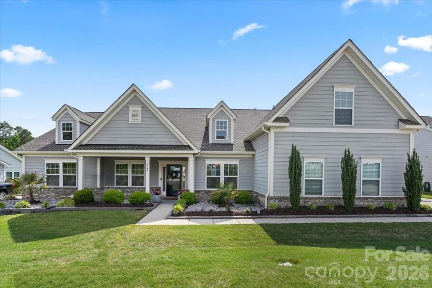 Welcome to one of Waxhaw’s most rare and sought-after ranch-style homes, offering just under 3,400 sq ft, 4 bedrooms, 4.5 baths, and an impressive 4-car garage—an exceptional combination of space, design, and functionality that rarely comes to market.

Designed for both elevated everyday living and effortless entertaining, this open-concept home features soaring ceilings, rich wood flooring, and refined architectural details throughout. The inviting family room showcases coffered ceilings, surround sound, and a cozy fireplace, seamlessly connecting to formal living and dining spaces.

The primary suite is truly a private retreat—featuring an expansive sitting area comparable in size to a two-car garage, along with dual closets and a spa-like feel. Each bedroom offers its own en-suite bath, with an additional upstairs suite perfect for guests or flexible living.

Step outside to your own peaceful escape. The beautifully landscaped, private backyard is framed by palm trees and features a screened-in porch and extended patio—ideal for relaxing evenings or hosting gatherings year-round.

Located in the highly desirable Greenbrier Estates community with resort-style amenities including a pool and sidewalks, and just minutes from the charm of downtown Waxhaw and the shopping and dining of Wesley Chapel.

Homes with this layout, level of privacy, and garage capacity are incredibly rare—schedule your private showing today.