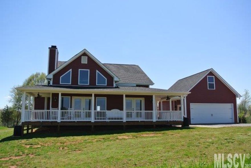 Enjoy relaxing on the front porch of this immaculate three bedroom, two and half bath home on 13.38 acres!  Home has open concept with beautiful, light Hickory wood floors, island dining area & wood burning fireplace. Large windows for lots of natural light. Master bedroom on main with walk-in closet & master bath. Second level has a bedroom, bath & loft area. Kitchen has a large pantry. Detached, double garage with additional unfinished room upstairs. Green house & additional building will remain.