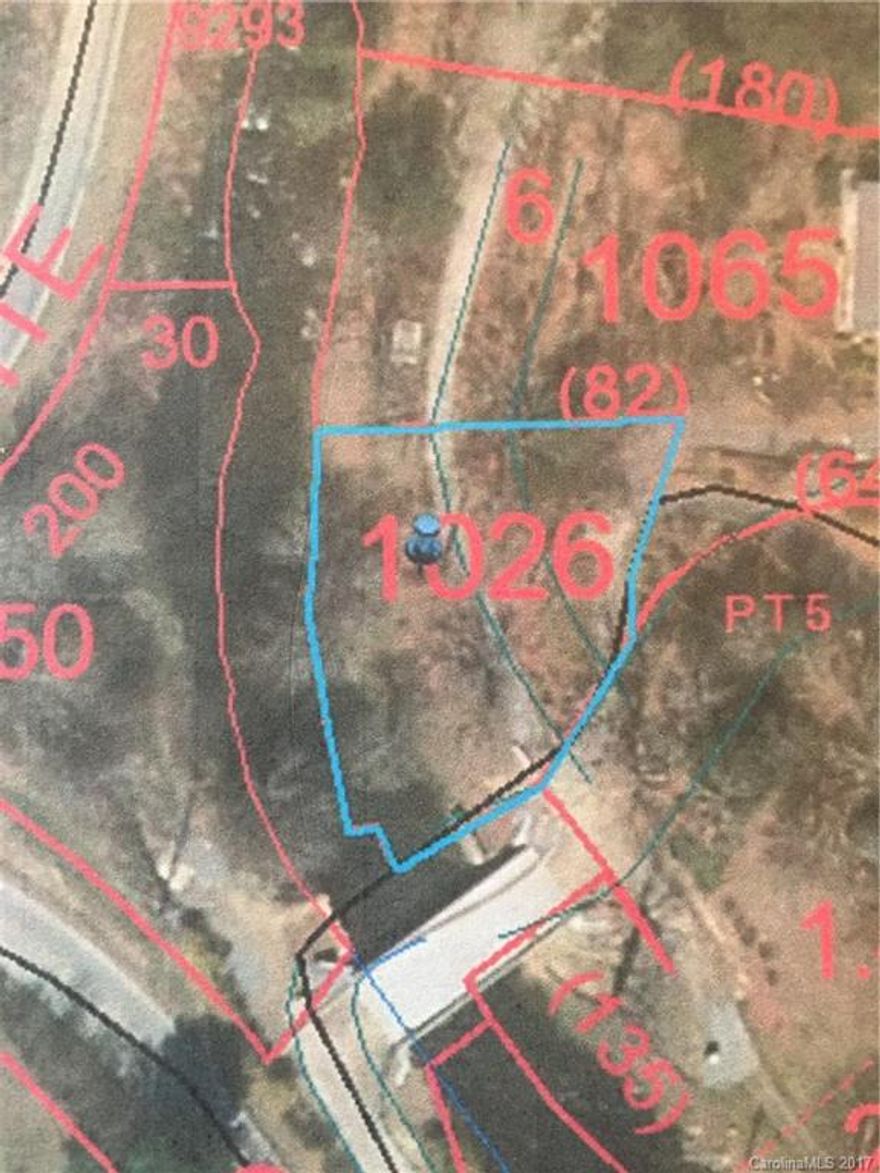 Level lot sitting on Jonathan Creek with completely paved access.