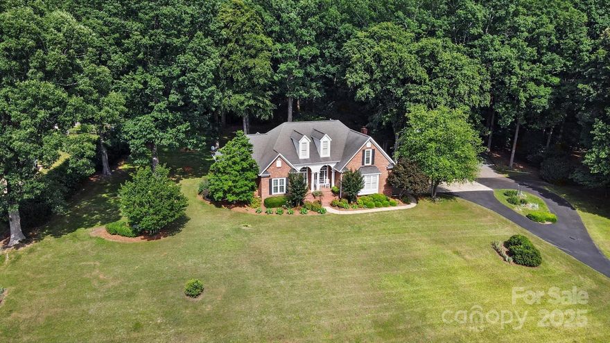 Nestled on a private ~2.48 acres, this charming custom-built brick home sits atop a hill offering the perfect blend of charm, space & serenity! Surrounded by mature trees in the back, the setting feels like your own peaceful retreat. Inside, the home boasts 3 bedrooms (all on main level), 2.5 bathrooms, and an open 2-story living and dining space filled with natural light & hardwoods. The spacious primary suite includes a WIC and huge bathroom. Upstairs features a bonus room & walk-in attics (don't miss the finished closet space w/vents). An enclosed sunroom offers year-round enjoyment of the scenic surroundings. Out back, a brick patio ideal for grilling out, a covered gazebo for relaxing outdoors, and a detached 12x20 shed w/ electricity—great for workshop or storage. No houses behind you with the Stevens Creek Nature Preserve (enjoy exploring trails & the nature center). This property offers a rare blend of privacy and space-all just a short drive to downtown Matthews or Mint Hill!