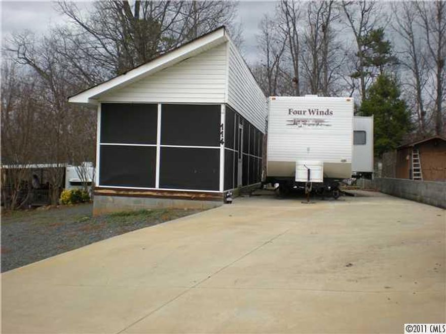 $27,900 price is now without the camper. Camper is negotiable.
MAKE OFFER.........  Gated community. Badin Shores Resort: pool, beach, club house, store, boat ramp, and much more.  Extremely clean & well-kept 2 Bedroom & 1 Bathroom camper w/screened porch addition.  Large concrete pad on a flat lot, which makes it very appealing. A perfect place to relax & enjoy Badin Lake!  Lot # 708. Must see! Call BECKI RICE REALTY 336.461.HOME