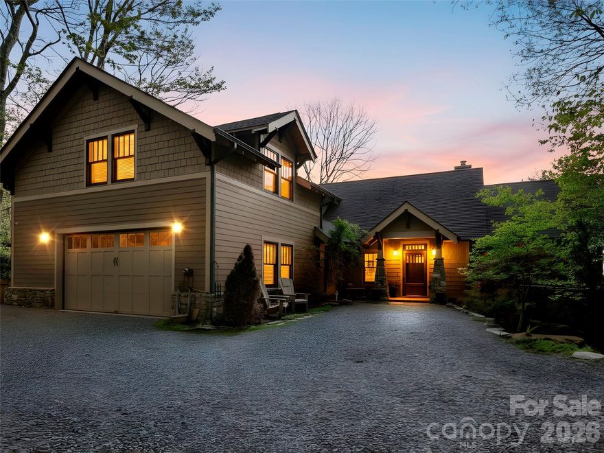 Perched at its nearly 4,400' elevation, this exceptional Arts & Crafts mountain retreat captures breathtaking layered long-range mountain and valley views with its prized southeastern exposure. Thoughtfully designed for both luxury and comfort, the home features three spacious primary suites: one on each level, providing ideal accommodations for family and guests. The chef's kitchen is beautifully appointed with premium appliances and finishes, while the dramatic great room showcases abundant windows, a cathedral ceiling, a luxe onyx stone fireplace, and dining room with a coffered ceiling. Rich oak hardwood flooring, Marvin windows, zoned heating, and meticulous maintenance throughout reflect the home's outstanding quality and craftsmanship. The lower level offers an inviting wet bar and additional gathering space, complemented by a second stone wood-burning fireplace. The outdoor living spaces are equally impressive and feature composite decking on the main deck, screened grilling porch, a large screened porch, and the fire-pit area is perfectly positioned to enjoy the spectacular mountain setting while making s'mores with the family. Additional highlights include a whole-house generator, oversized garage, and the privacy and security of an upscale gated community located just minutes from downtown Waynesville.