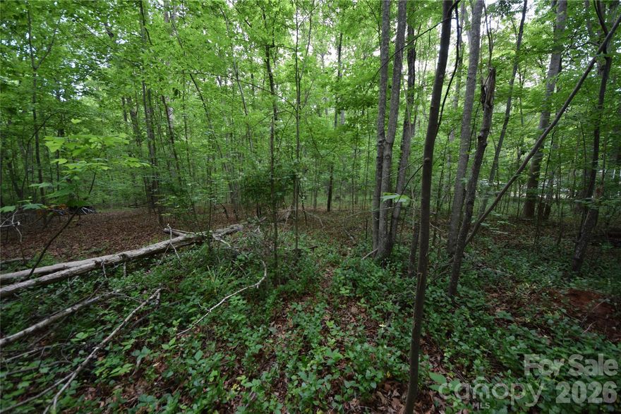 GREAT OPPORTUNITY TO OWN 9 GREAT ACRES IN THE CLOVER/YORK AREA OF SC.  The land is partially level in the front and then goes down to a creek and up the hill to a large section of flat land.  Lots of hardwood trees and pines.  At this time there is a 2000 square foot home that's on the property. It's a 1969 Shelby mobile home that has been added on, added on and added on.  Note: The additions were done without permits.  The home is occupied, and they have a wood burning fireplace and a window AC unit. The well and septic work fine. THIS HOME IS SOLD AS IS.  You can inspect anything you like, just know the owners will not be doing any repairs.  The septic permit is not available. There is no county water or sewer available. York county gas is available. Most everything will convey inside and outside. Mobile homes allowed. Around the home you will find numerous types of trees, bushes and shrubs.  Just to name a few, Palm, Ginkgo, Japanese Maples of different varieties, Apples, Peach, Poplar, Holly, Oak, Bird of Paradise, Bamboo and Crab Apple.  They have built several flowing ponds on the property.  Along with all this, you be close to all your shopping, restaurants, Clover Schools and the famous Lake Wylie.