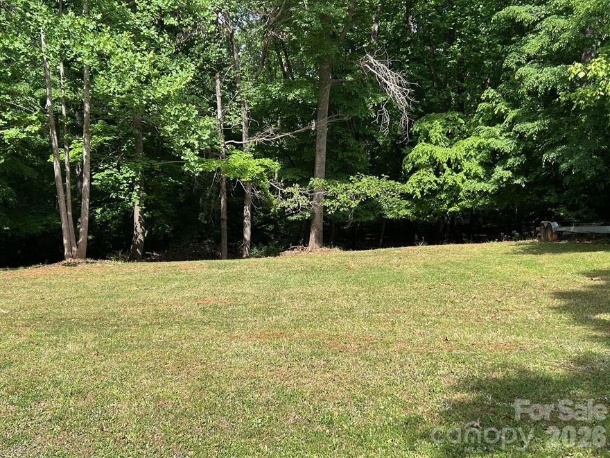 Enjoy the freedom of no HOA and flexible building options including modular, manufactured, or a double wide home on this level, cleared, tree lined, just under 1/2 acre lot, in highly desirable Mooresville! Conveniently located near Hwy 150 with easy access to shopping, dining, schools, medical facilities, and all Lake Norman has to offer!  Perhaps you're just needing storage? This lot would also be perfect for a large secondary garage, boat storage, RV storage, trailer storage, equipment storage or a great workshop — endless possibilities on this unique property! This property already has an existing well and septic, adding tremendous value and convenience for your future build. Plenty of mature trees provide privacy and a peaceful setting while still being close to all the amenities Mooresville has to offer.  Located nearby boat launches and lake access areas, makes this property perfect for lake lovers and outdoor enthusiasts. Rare opportunity for affordable land in a fast-growing area — bring your vision!