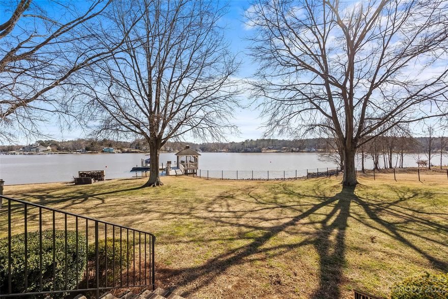 Live in style with an Old World feel in this stunning Lake Front property w/big water views. This Main Channel Home is on a point w/over 160' of shoreline. A level lot provides year-round enjoyment in a prime Lake Wylie location. Enjoy outdoor living while relaxing on the screened gazebo or float on the dock & watch boats cruise by. Perfect for boating, swimming, or fishing. The Lg. brick patio offers a ton of space for outdoor entertainment. Loaded w/character, this waterfront retreat shows off antique heart pine flooring, a chef’s kitchen w/high-end appl., Lg. island, & a sitting rm w/cozy gas FP. The spacious family rm, w/wood burning FP, has a wet bar & built-ins galore. The primary BR w/en-suite was upgraded and on the main level & offers tall windows for natural lighting. Sleep, work, or craft in the lg. upstairs bonus w/full bath. Warm & inviting, start making memories in this waterfront retreat. Clover Schools! See feature sheet for recent upgrades.
