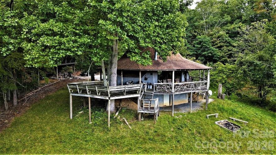 Beautiful UNRESTRICTED 34- acres of mixed wooded and pasture land with a geodesic dome home. One bedroom & 1.5 baths comes mostly furnished.  A wrap around porch is wonderful to view the mountains in the distance and pasture area.  A barn and outbuilding that could be a second home are on the larger parcel.  Could make a wonderful development with several homesites, homestead or campground with an average slope of 27 percent.  Cascading creek provides a border on one side.  Property is located between Bear and Wolf Lakes making it ideal for the lake enthusiast and nature lover. Seller has gone through the process of abandoning the well since it's on USFS land and redirecting the driveway off the USFS land.  The parcel with house and 7.03 acres is being sold for $250K cash since it will not have a water source and the 26.85 acres can be conventional financing. Both parcels must be bought at same time. Mathis Cemetery shares road for cemetery access as shown on bottom of survey. Property is being sold "As Is".