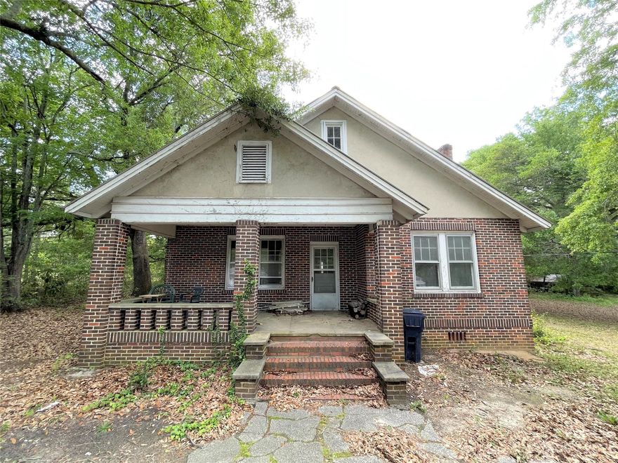 This charming brick Craftsman style home has so much potential! With some original hardwoods and beautiful molding, this home features some lovely details just waiting for your personal touch to make it your dream home or investment property. It has three bedrooms and one bathroom, and it is located on a large 1.8 acre lot. There is a large unfinished attic that offers ample storage or possibility for future expansion. There is oil heat (oil tank located in the back yard) and central air. The home is being sold as-is.
