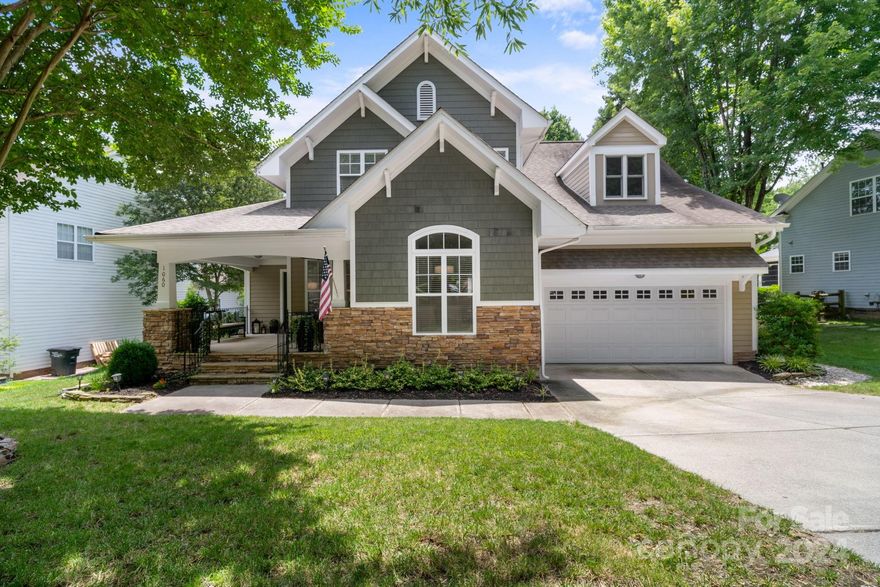 Welcome Home to 1060 Hunters Run Dr! This beautiful 4 bedroom home features the master on the main floor, hardwood floors throughout, lots of natural light, an updated kitchen with gas range, and a nice spacious floor plan. The master bedroom is complete with a custom closet system, and an ensuite which includes a separate shower & garden tub to relax in. Upstairs you'll find 3 additional bedrooms and a full bath. The 4th bedroom/bonus room has 2 walk-in attics for extra storage. Lots of options to enjoy the outdoors or entertaining on the large front porch, tranquil back deck, or on the new back patio. Tega Cay has no HOA dues but does have amenities including 10+ parks, beach & lake access, walking trails, optional swim club/pool with gym, optional golf membership, tennis & pickleball courts & easy access to the elementary school. Plenty of shopping nearby and easy access to I-77 to get to Charlotte. Come see what living on the peninsula is all about & make this home yours today!