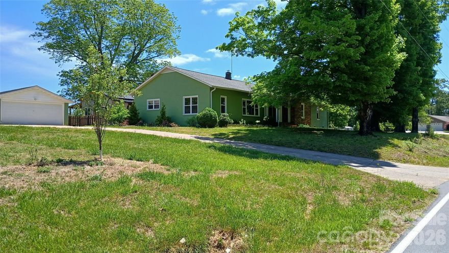 Ranch Farmhouse on 4.75 Acres in Rutherford College – Country Living in Town. Rare opportunity to own a beautiful mostly updated farmhouse situated on 4.75 acres in the heart of Rutherford College. Enjoy the perfect blend of privacy and convenience with expansive indoor and outdoor spaces. This property is ideal for sustainability enthusiasts, featuring a dedicated garden area, fruit trees, space for greenhouses, and a cold room for storing fresh vegetables. Multiple outdoor water spigots make irrigation simple and efficient. The home offers generous living space, including the main living area with impressive 9.5-foot ceilings. The large kitchen is a standout, complete with abundant cabinetry and room to gather. A mudroom/laundry area adds everyday functionality. Recent updates include newer carpet and refinished hardwood floors. The primary suite features a handicap-accessible bathroom for added comfort and accessibility. Outside, you’ll find a detached 2-car garage with additional storage and a cooling room for crops, plus a separate carport/tractor shed. The fenced backyard includes a play area, and the back porch provides the perfect spot to relax with your morning coffee. This property offers space, versatility, and charm—truly a must-see to appreciate all it has to offer.