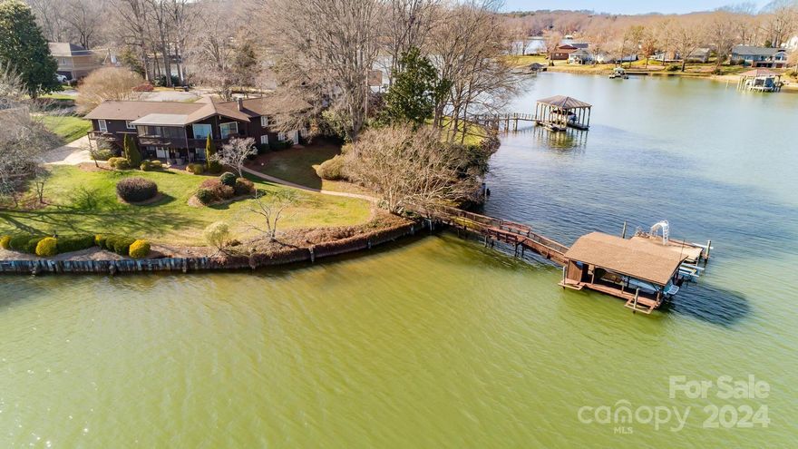 Look no further your dream waterfront home awaits! Situated on a prime peninsula lot with.43 acres & over 220' of shoreline with fabulous panoramic views, a seawall & deep water. Large private pier & covered dock with 2 boat lifts & 1 jet ski pad. This ranch boasts 4 bedrooms & 3 full baths & 2 car garage with a finished basement. You'll love the open floorplan & cathedral ceiling in Great Room with with lots of windows to take in the great water views & morning sunshine. Large fieldstone fireplaces up and down in the lower level entertainment area. There is a spacious kitchen with center island with seat at bar with a waterfront view while at the sink! Relax on the screened porch while enjoying BIG lake views. Lincoln County was unable to locate the original septic permit but the good news is there are sewer lines up at the street. Situated in a prime Westport location on a quite cul-de-sac close to restaurants, shopping & has quick access to the airport & Charlotte.