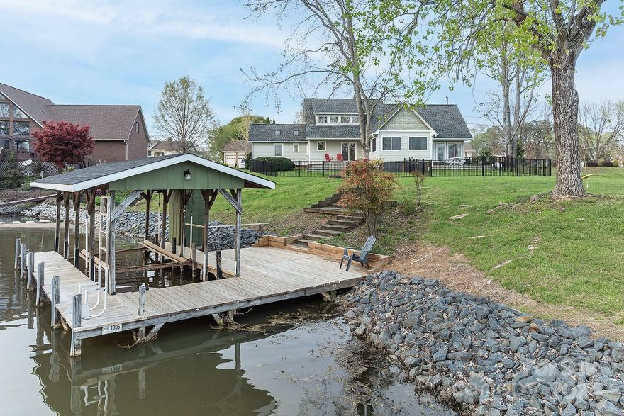 Beautifully designed waterfront home on flat lot! So many architectural features to enjoy in this custom home. Wonderful open floor plan with soaring ceilings in the great room and open kitchen with beautiful white cabinetry, granite countertops, and fantastic breakfast bar area. Gas logs with gorgeous mantel with granite for cozy evenings. Lots and lots of glass to bring the lake view inside fantastic and rather large sunroom with wooden cathedral ceilings, built-in wet bar, and complete open view of Lake Tillery! Primary bedroom suite on the main floor with fireplace, private office, large bathroom with sunken tub, double vanity, cathedral ceilings, and oversized tile shower. Awesome spaces for entertaining! Two separate open decks for entertaining or quiet time just enjoying the beautiful scenery. Beautiful lawn and mature shrubbery, boathouse with boat lift. Lots of Waterfront in this small cove and a tremendous long range view! Beautiful home that you must come see!
