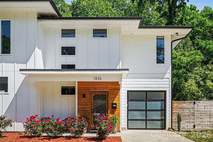 This striking contemporary home blends modern design with thoughtful, high-end finishes, creating a space that feels both elevated and inviting from the moment you arrive. The clean architectural lines and curated landscaping set the tone, while a welcoming covered entry with warm wood accents adds an immediate sense of style and intention.

Inside, the home opens into a bright, airy layout filled with natural light and upscale touches throughout. Wide-plank flooring flows seamlessly across the main living areas, complemented by a soft, neutral palette and designer lighting that enhances the home’s modern aesthetic. The kitchen is a true centerpiece, featuring an oversized island with seating, sleek cabinetry, and a polished, open design that connects effortlessly to both the dining and living spaces—ideal for entertaining or everyday living.

The attention to detail continues upstairs, where the primary suite offers a refined retreat with generous proportions, a custom walk-in closet, and a spa-inspired bath complete with dual vanities, elevated finishes, and a beautifully tiled walk-in shower. Secondary bedrooms are equally well-appointed, while additional spaces provide flexibility for a home office, guest rooms, or creative use. The laundry room is thoughtfully designed with built-in storage, adding both convenience and style.

Outdoor living is just as impressive, with a fully fenced backyard designed for both relaxation and entertaining. A spacious patio creates the perfect setting for gatherings, while the private yard offers plenty of room to unwind in a serene, tree-lined setting.

Located in the sought-after Eastwood area of Charlotte, this home places you just minutes from Plaza Midwood, NoDa, and Uptown, offering easy access to some of the city’s best dining, shopping, and entertainment. Enjoy the charm of an established neighborhood paired with the convenience of nearby urban amenities, making this an exceptional opportunity to experience modern living in one of Charlotte’s most vibrant and connected locations.