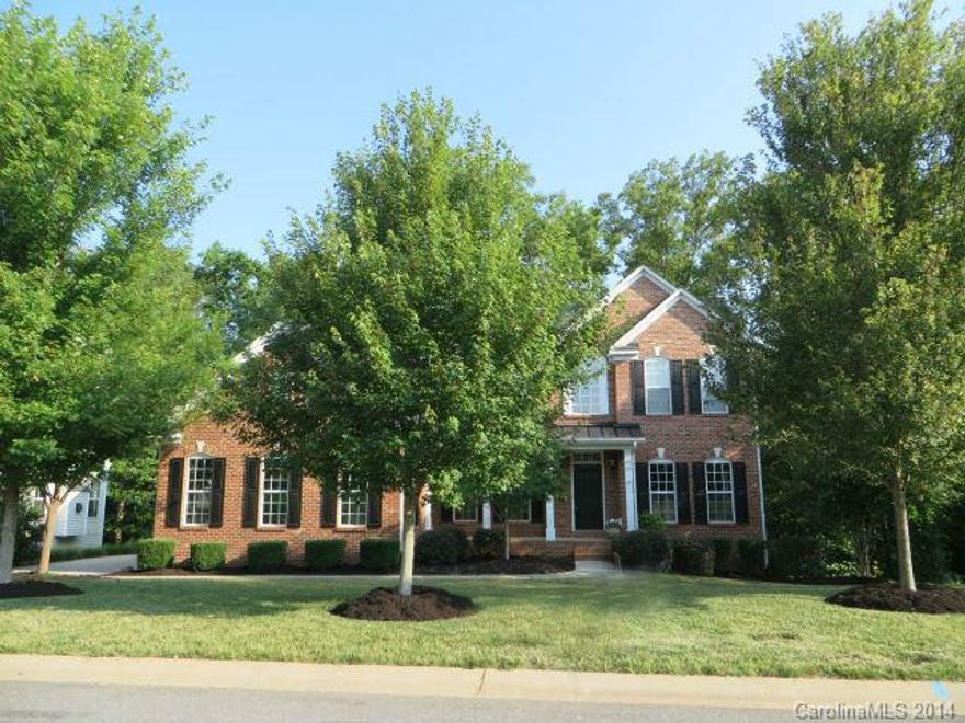 Incredible amount of living space w/this 2 story brick front home that has finished walk-out basement. Gorgeous Kitchen w/ double oven, gas cooktop, center island. Refrigerator incl. Delightful Sun Room w/wooded views. Formal DR. Office or LR w/french doors. 2 story GR w/FP. Master on main w/2 closets, garden tub, dual vanities, sep shower.  3 BRs, 2 full baths up (one a guest suite). Plantation shutters in all BRs.  Large workshop, Rec & Media Room in basement. Award-winning Ft. Mill Schools!