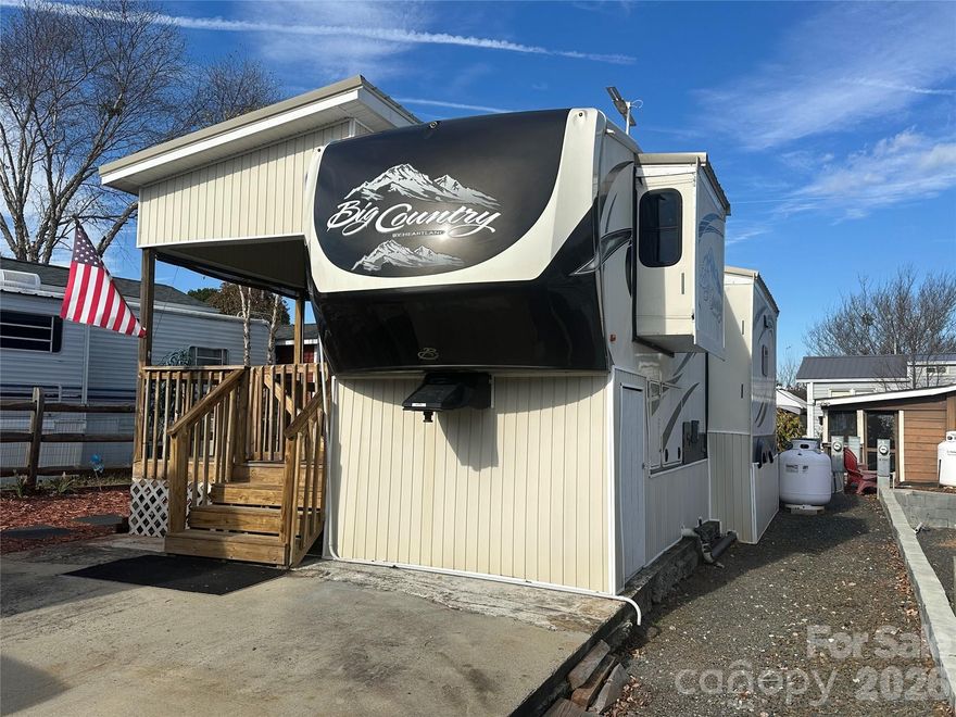 Don’t miss out on this beautifully maintained and fully furnished 2015 fifth-wheel camper, permanently set up on a deeded and level lot in the gated waterfront community of Badin Shores Resort. This spacious home features an open kitchen with a center island sink, abundant cabinetry, and a full-size refrigerator. The inviting living area offers an entertainment center with an electric fireplace—perfect for relaxing after a day on the lake. The bedroom provides generous closet space, built-in storage, and a designated area for a future washer/dryer combo if desired. Outside, the wired storage building with its own air conditioning is ideal for hobbies, projects, or comfortable storage year-round. Enjoy evenings outdoors on the covered porch or the newly constructed wooden patio with arbor—perfect for grilling, gatherings, or simply unwinding. A great opportunity to experience lake resort living at its finest!