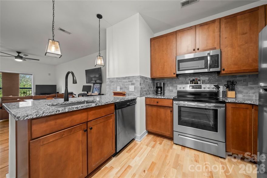 Don’t miss this Uptown studio condo in Skybridge Terrace! One of the standout features of this building is the convenience of elevator access. The kitchen features granite countertops, a tile backsplash, and stainless steel appliances, and flows seamlessly into the dining area and living space—perfect for easy everyday living. The thoughtfully designed layout includes a designated bedroom area with a closet, offering separation and storage while maintaining an open studio concept. The full bath offers a granite-topped vanity and a convenient laundry closet. Notable updates include a new roof in 2024 and a water heater and HVAC replaced in 2019. Ideally located near the Greenway, local restaurants and shopping, Uptown, and Bank of America Stadium, this condo offers both comfort and convenience. Come see everything this property has to offer!
