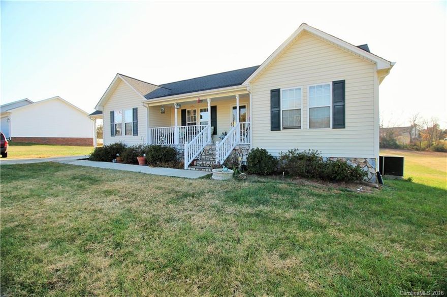 Don't miss this well maintained 3 bedroom 2 bath ranch home with great open floor plan on level acre lot in Lincoln County! Beautiful laminate wood flooring in kitchen, dining, living & hallways. Relax on the large covered front porch or the spacious back deck. Plenty of room for a pool if you would like to add one. Lots of storage including a huge 16 x 20 building with lofts.  Covered carport with storage closet and lots of extra parking on the driveway. Country living just 5 minutes from town!