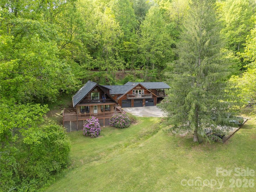With more than 2500 sq ft spread over TWO separate living spaces, this updated, unique property offers privacy AND long-term rental potential in the sought-after Village of Forest Hills. With 4-bedrooms + flex space and 3 full baths, this home features two connected living spaces, each with its own distinct entrance, separate decks, and full living amenities — ideal for multi-generational living, guest quarters, a private apartment suite, or owner-occupied long-term rental potential, all just 5 minutes from Western Carolina University.

Major updates include a new roof and skylights (2023), two new water heaters (2023), Hvac systems (2020), and fresh neutral paint throughout.

The main home features an open-concept living area centered around a stunning stone fireplace with gas insert, surrounded by windows that fill the space with natural light. The kitchen, living, and dining areas flow easily for everyday living and entertaining. The main level also includes a guest bedroom, updated full bath with stunning walk-in tiled shower, laundry room, office/flex space, and mudroom/drop zone with additional storage for outdoor gear and everyday organization.

Upstairs, the spacious primary suite includes a private balcony perfect for morning coffee, plus a loft area ideal for storage, a reading nook, or additional sleeping space. An oversized secondary bedroom with three closets and another full bath complete the upper level.

Above the three-car garage, the separate apartment-style living quarters offer exceptional flexibility. Filled with natural light from multiple skylights, this updated space includes vaulted ceilings, a full kitchen with butcher block countertops, high-end LVP flooring, laundry closet, updated bath with a gorgeous tiled shower, huge private deck, and a one-bedroom layout connected to the main home through a lockable interior passage.

Whether you’re looking for space for extended family or the opportunity for supplemental long-term rental income while owner-occupying, this one-of-a-kind property offers possibilities that are hard to find this close to WCU and the new recreation center.