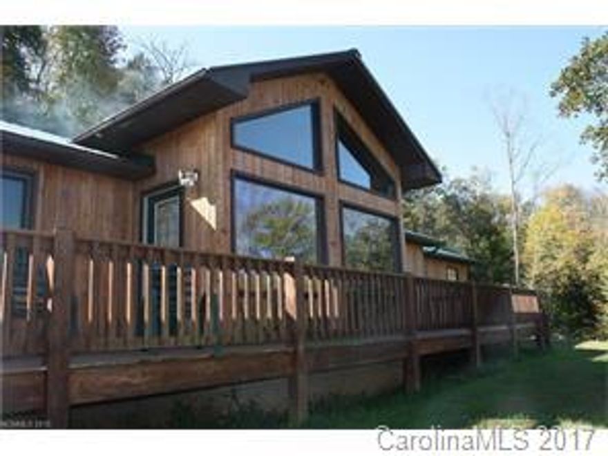 What a beautiful private home located on 38 +- acres of lush land. Some cleared and some wooded and most everywhere is a beautiful mountain view. Play in the streams, keep your  horse in the barn.   Great for hunting , hiking, and super fishing in the nearby Toe River. The nice cypress home has vaulted ceilings, fireplace, huge windows for views, full basement and so much more. Additional acreage may be available.