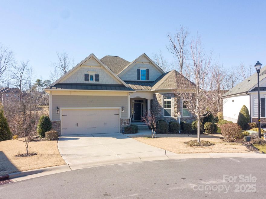 This immaculate one-story home blends privacy, luxury, comfort & functionality. It is located in a small community, nestled on a quiet cul-de-sac that overlooks a private area w/ mature trees & a gently flowing creek. The home features wood floors, high ceilings, 2 spacious bedrooms & generous flex space (currently a DR) & a  fully insulated garage, perfect for working on cars/projects. The kitchen boasts stone counters, 10-foot island w/breakfast bar, built-in oven & microwave, 5-burner gas cooktop, soft-close cabinets & walk-in pantry. GR features a gas FP & 25' wide panoramic sliding-glass doors that lead to a covered deck, perfect for entertaining or unwinding. Deck extends further w/a sitting area, hot tub & retractable awning. Primary suite features a tiled walk-in shower, double sinks & a generous walk-in closet. The fully-insulated, walk-out basement (roughed in for plumbing & HVAC) provides endless possibilities. Lush landscaping & stone accents enhance the homes curb appeal.