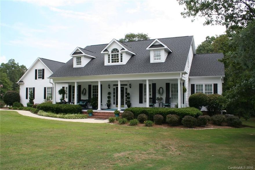 You'll be delighted to tour this truly one-of-a-kind estate type "Low Country" styled home on nearly 2 acres, in northern Union County, minutes from Hwy 601 and I-485. Resort style pool with a brand new liner, huge deck, and a large outbuilding/workshop that has water and electric. Relax on an authentic southern-style rocking chair front porch at the end of a long day. Interior features include finished on-site HW floors, soaring great room ceilings, and a deluxe master suite on the main level.