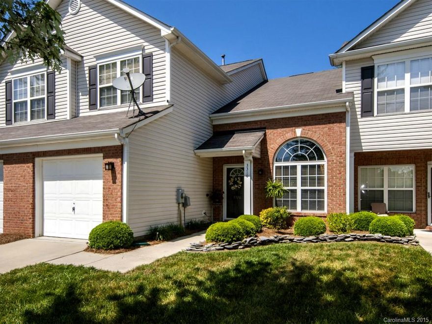 Lovely, extra clean, extremely well kept two story townhome with a master bedroom on each floor.  So pretty with a partial brick front, garage and a cozy, private patio area surrounded by trees. Loft upstairs. Downstairs has hardwoods throughout except laminate in the bedroom. The refrigerator and garage shelves will remain. A tankless water heater was recently installed! HOA dues include use of pool, playground, WATER, TRASH pick up, exterior maintenance, and lawn car!