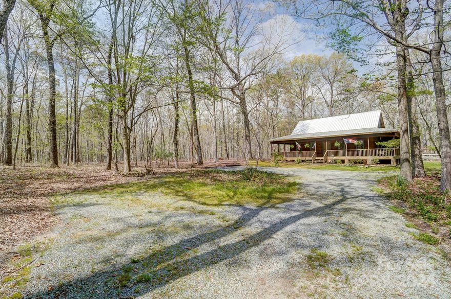 Homesteaders, outdoor lovers- THIS is it! A piece of heaven just south of Waxhaw. Love the sound of a gravel drive? Welcome home, come sit on the wrap around porch, listen to nature & breathe. This home lives large with a family room featuring a gas stove, a large kitchen w/a multitude of cabinets, a dining room that overlooks an amazing perennial filled backyard, a 1/2 bath, huge laundry room/pantry with built ins & finishing out the 1st floor is the primary w/ ensuite. A REAL claw foot tub is longing to be of service & after a nice bath check out the side porch off the primary. Upstairs is a great flex space, 2 ample sized bedrooms & an updated guest bath. The back screen porch will be a place to covet. Enjoy the partially fenced backyard featuring beautiful landscaping. The wired garage, chicken coop, tree house, raised beds & shed lend themselves to self sufficient living if desired. A quick walk takes you to Cane Creek where you can enjoy fishing, hiking, horseback riding galore.