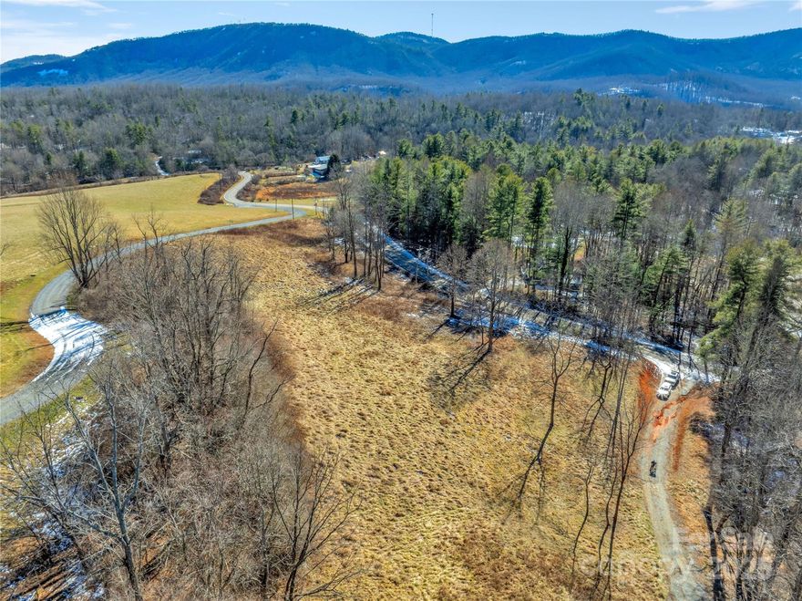 Beautiful gently rolling lot in Hendersonville near Jeter Mountain Farm.  This 4+ acre property offers an easy build site with minimal clearing and beautiful mountain views. This lot stretches across both sides of Ebenezer trail with build sites on one side and stream/creak on the other. Underground electric installed and fiber optic available. Gentle restrictions allow for livestock and barn.  Don't miss your opportunity to build your dream home in Western North Carolina near downtown Hendersonville, Brevard, and Dupont State Forest with year-round views.