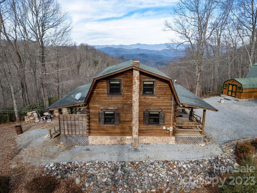 You will love this ultra private mountain cabin with long-range, year-round views, and the sounds of a waterfall from your wrap around porch. Nestled at the end of the road in a 7.66-acre, park-like setting, this charming log cabin has so much to offer. Inside you will enjoy the open floor plan, gorgeous stonework, and that cozy cabin feel as you relax by the warmth of the wood stove. Outside you can entertain guests from your expansive decks as you enjoy beautiful sunsets and the view of the Blue Ridge Parkway. There is plenty of room for all of your outdoor activities. It boasts a 2-car garage, a workshop, and a storage building. The acreage is very wooded and private. The Northwest side of the property is boarded by Shoal Creek, a bold year-round stream. All of this combined with an abundance of wildlife make this the ultimate mountain home or part time retreat! The home is priced below the current appraisal which is attached to the listing. This home is truly a must see!