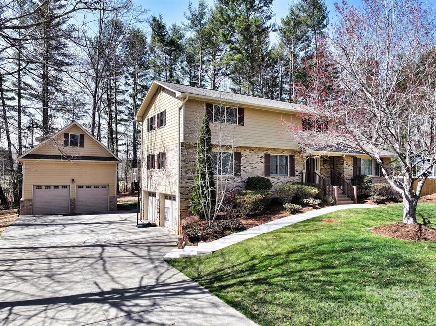 This charming two-story brick home is tucked in a quiet, welcoming, established neighborhood, exuding warmth and character. The front porch invites you to relax and enjoy the neighborhood views, offering the perfect spot for a morning cup of coffee or evening conversations. Inside, natural light fills the spacious sunroom, a serene retreat ideal for unwinding or enjoying the changing seasons. Freshly painted and meticulously maintained! At the back, a large deck extends the living space outdoors, perfect for hosting barbecues, family gatherings, or simply soaking in the tranquility of the backyard. With its classic brick exterior and thoughtful design, this home offers both comfort and style in a friendly, peaceful community.The second garage is a car lover's paradise, featuring two spacious bays and a lift, providing the perfect environment for working on and storing prized vehicles. It's a well-equipped space designed for enthusiasts, blending functionality with a passion for cars