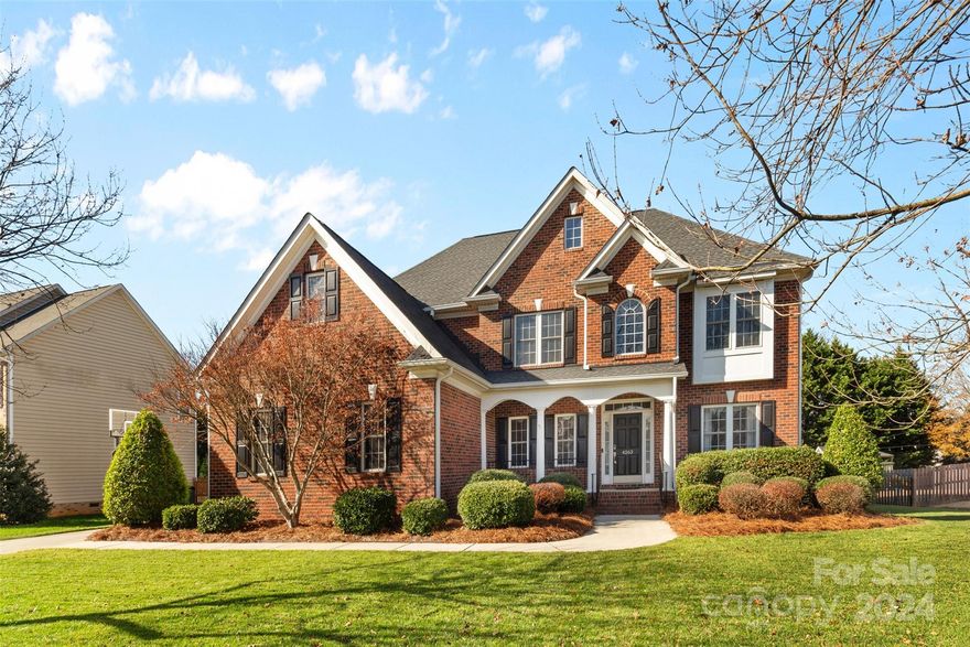 Extraordinary 5 bedroom Belmont estate, situated on a sprawling .37 acre lot with an outdoor fireplace, large patio and expansive porch for true outdoor living! Upon entering, you'll notice the sweeping hardwood floors throughout the open concept main level, with a dedicated dining room & office space. Continuing on, you'll find the expansive living room with a fireplace that flows seamlessly into your breakfast area & kitchen for easy entertaining. Your chef's kitchen includes ss appliances that convey with the home, pantry & plenty of countertop & cabinet storage space. The bed & full bath downstairs make for the ideal MIL or guest space. Upstairs, you'll find a bonus/flex space, as well as the remaining 4 bedrooms. Your primary oasis boasts tray ceilings & an enviable en-suite bathroom with soaking tub, stand alone shower & massive walk-in closet. The secondary bedrooms are sizable & share a full bath. Outside, you'll enjoy evenings by the fireplace overlooking your fenced-in yard!