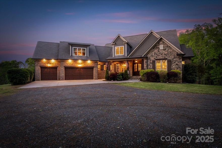 Welcome to a rare blend of luxury, privacy, and rustic elegance at this beautiful custom home nestled on 6 acres. 
Step inside to find grand spaces featuring cathedral style ceiling with wood planks, custom chandeliers, and elegant stone fireplace that create a warm yet sophisticated ambiance. The main-floor living areas are anchored by a spacious gourmet kitchen equipped with a stone bar and beverage center, perfect for entertaining. Step outside on the main floor veranda to enjoy abundance of wildlife, lush landscapes, and the charm of true privacy ideal for outdoor gatherings. The oversized primary suite is on the main-floor . The fully finished basement boasts a 2nd kitchen, entertainment room, bar, office, and 2nd Primary suite making it a perfect 2nd Living Quarters.  Located just minutes from historic downtown Davidson, Birkdale, and within an easy commute to Charlotte, This home is a meticulously crafted sanctuary that embodies the pinnacle of extraordinary living.