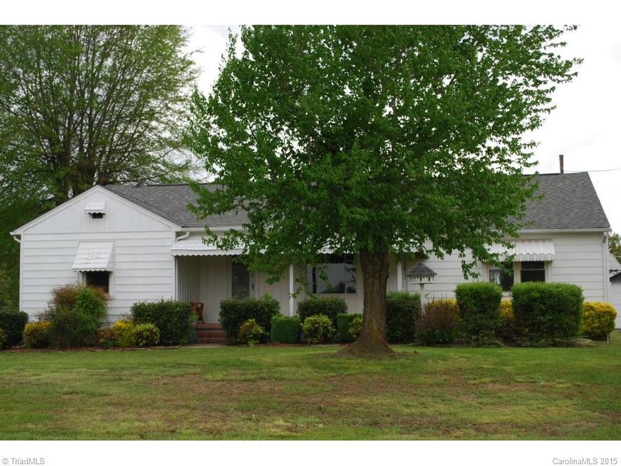 Lots of property for the Price!  Well kept 3 Bedroom, 1.5 Bath home with 2 enclosed garages, 3 car carport, 1 car carport, 12x24 finished building for hobbyist or at-home business, 8x10 storage building, tool shed, paved drivway, garden space. Home has front covered porch, screened back porch and deck. Beautiful hardwood flooring in 2 bedrooms just refinished, freshly painted interior. All roofs replaced within last 3 years. Heat pump only 2 years. old.