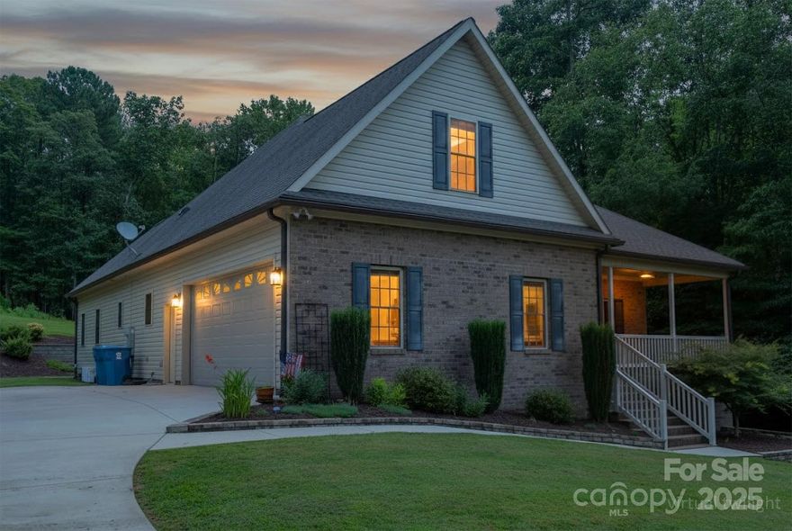 PRICE DROP!! Built in 2015 and located directly across from Lake Norman with seasonal water views, this beautifully maintained, immaculate home offers everything you need all on one level. Offering both elegance and ease. Featuring an open floor plan, this one-owner home boasts granite countertops, custom cabinets, elegant lighting, and a formal dining room, perfect for both entertaining and everyday comfort. On the main level, you can enjoy two spacious primary suites, each with walk-in showers and walk-in closets. Upstairs, you will find a third private bedroom suite above the garage with its own full bath and mini-split system, ideal for guests or multi-generational living. The main level also provides a large laundry room with hideaway storage and a utility sink. The half bath is conveniently located off the oversized 2-car garage. Spend your mornings on the inviting covered front porch overlooking the lake or unwind on the peaceful covered back porch surrounded by lush, low-maintenance landscaping. Located in a prime area for commuters to Charlotte or the Greater Hickory area, this home delivers functionality, charm, and proximity to the water, only minutes from public access to drop your boat or jet ski in, everything you’ve been waiting for!