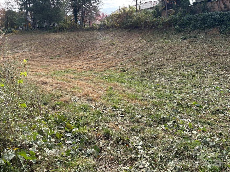 Excellent opportunity to own three buildable lots just minutes from the heart of Black Mountain, North Carolina!
Located near one of Western North Carolina’s most charming and vibrant mountain towns, these cleared lots offer endless potential. Black Mountain is known for its thriving arts and music scene, walkable downtown, and welcoming community atmosphere. Each lot provides flexible building options — from single-family homes to potential residential duplex construction (buyer to verify). City water and sewer are available, making development convenient and cost-effective. The lots are already cleared, saving time and expense, and are ideally situated close to shopping, dining, and local amenities. Whether you’re a builder, investor, or future homeowner looking to plant roots in the Blue Ridge Mountains, this is a prime opportunity in a highly desirable area. Lots are being sold together. The lots sell as one package.