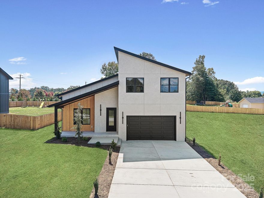 Custom built, Luxury Modern home located less than 2 miles from Hendersonville downtown!
This New Construction home boasts quality craftsmanship and functional living. Featuring 3 spacious bedrooms and an additional Bonus room, with a primary bedroom on each floor, showcasing beautiful glass showers and large walk-in closets.
Main floor invites you in, with high Ceilings, Cozy Fireplace, and an Open Concept Floor Plan leading you into the spacious kitchen with custom built, ceiling height cabinetry, beautiful Quartz countertops, stainless steel appliances and a great-size pantry. 
Covered deck out back, allows space for grilling and relaxation. For Convenience- Laundry and powder room located on Main floor. Upstairs you'll find a large walk-in attic for additional storage space. 
Additionally, the Home features, large walk-in closets with custom Built-ins, sound-proof walls, High-end LVP
Floors, Quartz countertops, and Custom Built cabinetry, with a 2 Car Garage. 
And Best Part-No HOA Fees, or Restrictions!