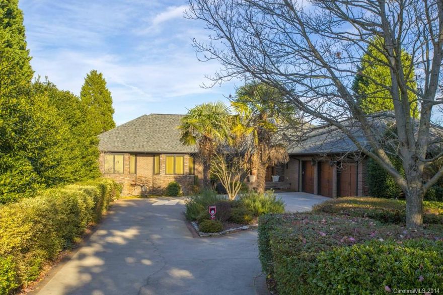 This updated custom home sits on one of the best lots on the entire lake measuring 1.3 acres!!! This home has been updated with the finest quality such as Wolf and SubZero. Incredible views from every room in the house. Master suite is on the main. Awesome covered porch with outdoor fireplace and built in grill station. Huge 3 car garage. Private Dock. Unbelievable custom master bath with huge shower, soaking tub, dual vanities and great closet space.