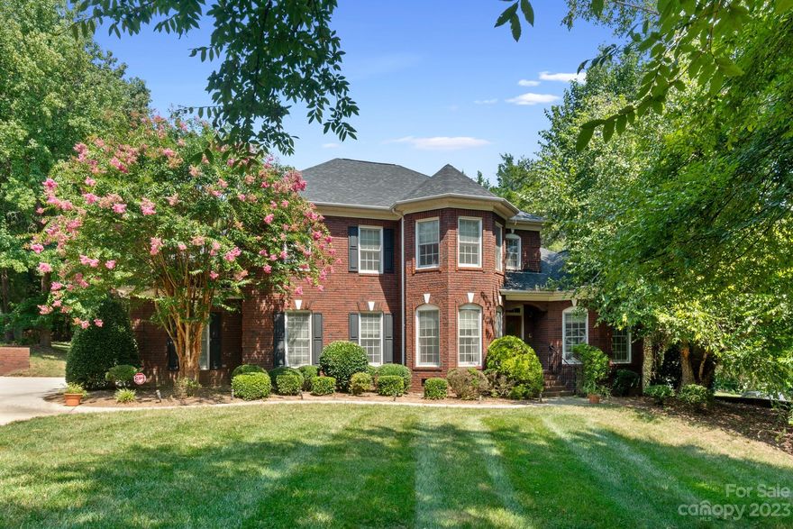 WOW...No HOA! NO DOWN PAYMENT financing available for qualified buyers! This stunning all-brick manor is nestled on an estate-size lot in this beautiful custom home community. As you enter, the grandeur of a two-story foyer and great room, architectural columns, an office/study and custom hardwood floors welcomes you.  Gourmet kitchen boasts granite countertops and stainless steel appliances. The main level Owners Retreat is a true sanctuary with its exquisite tray ceiling.  The opulent bath is equally indulgent featuring oversized shower and whirlpool tub for the ultimate pampering experience.  New carpet and paint throughout! Step out to screened deck and take in serene views of the wooded backyard, a private oasis where you can unwind or entertain.  Upstairs, discover a versatile bonus room that can serve as a fourth bedroom, or a rec room.  Yard features an irrigation system to ensure the outdoor space stays lush and vibrant year-round.