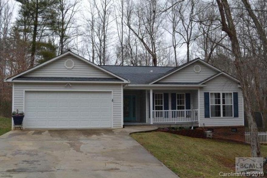 Beautiful three bedroom, 2 bath home situated on wooded 1.12 acre in desirable River Glen Subdivision.  One level open floor plan features cathedral ceiling and gas fireplace in living room. Kitchen has pantry, ample cabinets and all appliances. Laminate and ceramic tile throughout. Spacious master suite has adjacent area for small office, walk-in closet with adjoining bath. Double Garage with tankless gas water heater.  Relax on the back deck and enjoy the outdoors with your small creek or take a short walk to the Catawba River with a small park and trails.