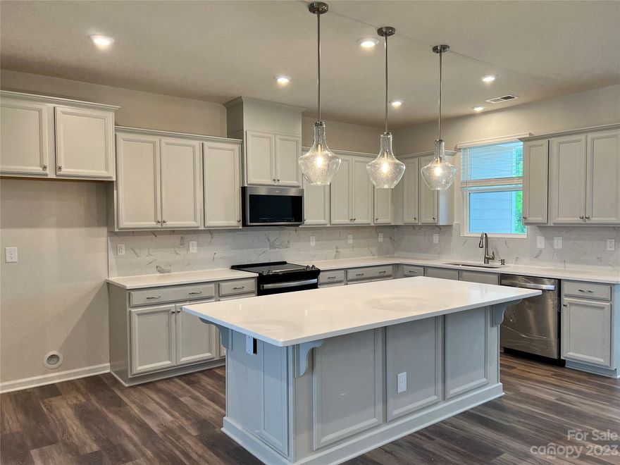 Tons of windows for natural light.  This 4 bedroom, 3.5 bath 2 car garage, fantastic for someone looking for single family home or townhome.  Double covered porches off the back of the home.  Plenty of room on each floor.  First floor has a guest suite with full bath.  Second floor has kitchen with large island tons of kitchen cabinets with upgraded appliances.  Large great room and private covered porch off the dining area.  Upgraded floors throughout.  Third floor has owners suite, large bathroom, walk in closet.  Down the hall has 2 additional bedrooms, hall bath, and laundry area.  Step across the street to The Chestnut Square Park with soccer field, tennis courts, volleyball, walking trails and indoor Carolina Courts basketball.  Next to the community will be a private swim club.  Union County taxes and schools.  Close to uptown Charlotte, Hwy 74 and I-485.