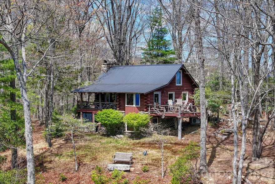 Welcome to 305 Stamey Creek, a rare offering of approximately 54 acres featuring a quaint log cabin-style home in the heart of Transylvania County. Ideally situated between Brevard and Rosman with close access to Highway 64, this property combines privacy and breathtaking natural beauty.

The cabin offers a warm, rustic feel that complements the surrounding landscape, creating a true mountain retreat. Step inside to a warm and inviting main level living room centered around a stunning rock fireplace, creating the perfect mountain retreat atmosphere. The main level features a well-appointed kitchen with breakfast bar, dining area, bedroom, and full bathroom, offering comfortable and functional living.

Enjoy seamless indoor-outdoor living with access to an open deck from the dining area—ideal for taking in the long-range views—or relax on the covered porch just off the living room and kitchen. A loft area overlooking the living room provides additional flexible space, perfect for a guest area, office, or reading nook.

The lower level offers a spacious sitting area with a second stone fireplace, ideal for gas logs, creating a cozy secondary living space. Just off the sitting area, step out onto a covered patio for even more outdoor enjoyment. The private primary suite is located on this level and features an ensuite bathroom, providing a peaceful retreat.

Enjoy stunning long-range mountain views for miles in both directions, visible year-round from the inviting porch—perfect for relaxing while taking in the scenery. 

The lower portion of the property opens up to an expanse of usable land, complete with a field and flowing stream, offering endless possibilities for recreation, gardening, or additional homesite. Whether you’re seeking a private mountain estate or investment opportunity, this property delivers unmatched potential in a highly desirable location.

Experience the best of Western North Carolina living with acreage, views, stream all in one exceptional property.