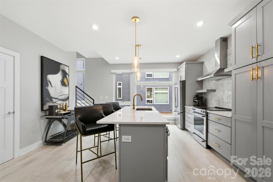 Experience refined urban living in this modern, luxurious 3 bedroom/3.5 bath townhome ideally positioned in the heart of sought-after South End. Thoughtfully designed across four levels, this residence is crowned by a private rooftop terrace, offering an exceptional setting for outdoor entertaining or quiet evenings above it all. Enjoy unparalleled convenience just blocks from South End’s acclaimed restaurants, breweries, boutiques, everyday conveniences and the Light Rail, offering effortless access to Uptown and beyond. The lower level welcomes you with a spacious tandem two-car garage, complete with a functional drop zone and a versatile bedroom or office, perfect for whatever your lifestyle needs! The main living level is an entertainer’s dream, featuring an open-concept layout anchored by a stunning chef’s kitchen with an oversized island, high-end stainless steel appliances, quartz countertops and abundant custom cabinetry. Seamlessly flowing into the dining and living areas, this space is ideal for hosting gatherings, pre-game entertaining or relaxed evenings at home. Upstairs, two generously sized bedrooms include a serene primary suite with a spa-inspired en-suite bath. The fourth level reveals a show-stopping rooftop terrace, offering an elevated outdoor living experience with sweeping views plus storage. Residents also enjoy access to a community dog park, completing this exceptional South End offering!